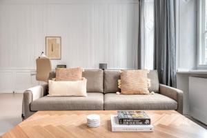 a living room with a couch and a coffee table at Cozy Flats in Heart of Copenhagen Near Strøget & Højbro Plads in Copenhagen