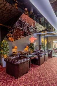 une salle d'attente avec des canapés en cuir et un bar dans l'établissement Villa Boutique Hotel, à Moukatcheve