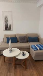 a living room with a couch and a table at Apartamento Centroplaya in Bueu