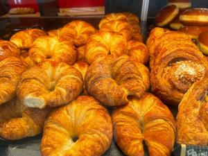 a bunch of croissants and pastries in a bakery at Le Rockastel in Le Caylar