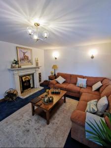 a living room with a couch and a fireplace at Bryn Mynach in Barmouth