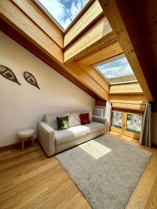 a living room with a couch and a skylight at Alpine Escape in Bormio