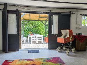 an open door to a patio with a stroller outside at Haus Lilli 
