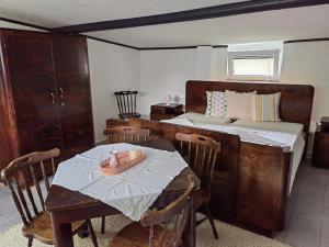 a bedroom with a bed and a table with a candle on it at Haus Lilli 