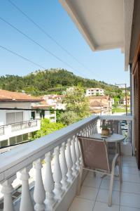 a balcony with a table and a view of a city at City Chic Apartments in Limenas