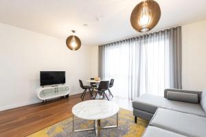 a living room with a couch and a table at Fernbank One in Dublin