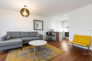 a living room with a couch and a table at Fernbank One in Dublin