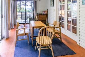 a dining room with a wooden table and chairs at Casual Lake Living in Union Pier