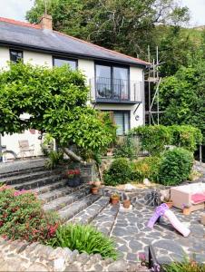 a house with a garden with a doll on the ground at Bryn Mynach in Barmouth