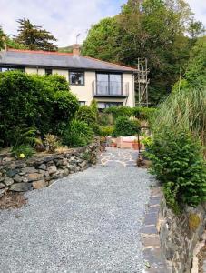 a house with a stone path in front of it at Bryn Mynach in Barmouth
