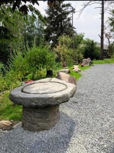 a stone bird bath sitting on the side of a road at Bryn Mynach in Barmouth