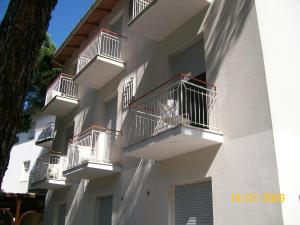 a white building with balconies on the side of it at Hotel Villa Alberta B&B in Cesenatico
