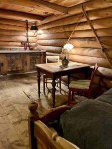 um quarto de madeira com uma mesa e uma cama em Stabburet på Gaarder / wifi og sauna 