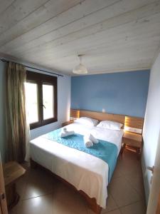 a bedroom with a large bed with two towels on it at Poli's Ideal Holiday Home - Fully renovated ! in Rakhónion