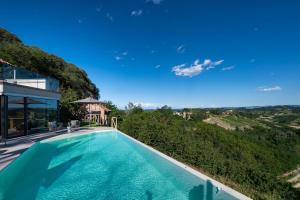 a swimming pool in a villa with a view at Relais Casa Clara in Montaldo Roero