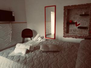 a bedroom with a bed with towels and a mirror at Casa Francesca in Mercato San Severino