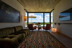 a living room with a couch and a table with chairs at Relais Casa Clara in Monteu Roero
