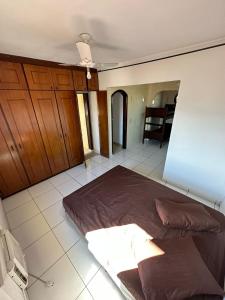a bedroom with a large bed in the middle of it at Hostel Canto da Ocian in Praia Grande