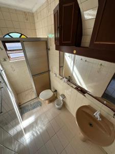 a bathroom with a sink and a toilet at Hostel Canto da Ocian in Praia Grande