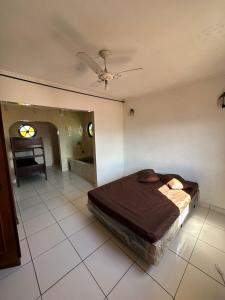 a bedroom with a bed and a table in it at Hostel Canto da Ocian in Praia Grande