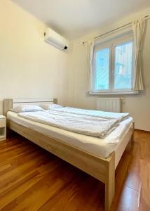 a large bed in a room with a window at Peaceful Place in Old Town in Bratislava