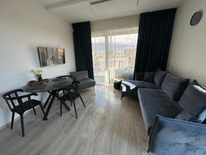 a living room with a couch and a table at VyJo Home Kunigiškės Mano jūra 2 in Palanga