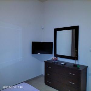 A television and/or entertainment centre at Villas On The Rock Afissos