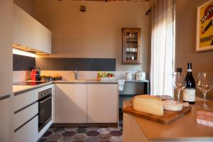 a kitchen with white cabinets and a counter top at Relais Casa Clara in Monteu Roero