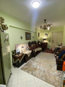 a living room with a couch and a table at Alex stay INN in Alexandria