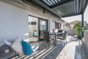 a patio with chairs and a table on a balcony at Apartment Rukavina in Njivice