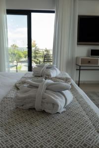 a bedroom with two beds with white towels on them at Ria Formosa Guest House in Faro