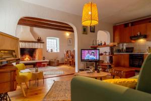 sala de estar con sofá y TV. en Authentic stone house Rustica near Makarska Riviera en Lovreć