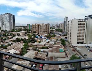 a city view from a balcony of a city with buildings at Lindo departamento equipado (Cercano a Terminal Sur) in Santiago