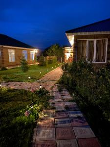 a stone walkway in front of a house at night at Бэй Хаус ( The Bay Area) in Cholpon-Ata