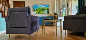 a living room with two chairs and a table at VillaMara Luxury rooms in La Spezia