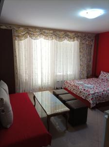 a small room with two beds and a glass table at Villa Ohrid Anastasia in Ohrid