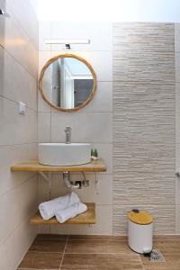 a bathroom with a sink and a mirror at Skopelos Panos Studios in Stafylos