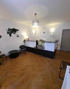 a waiting room with a counter and a clock on the wall at Albis Rooms Guest House in Fiumicino