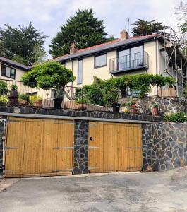 a house with two sets of garage doors at Bryn Mynach in Barmouth