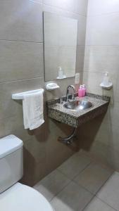 a bathroom with a sink and a toilet and a mirror at LA ESTACION in Gualeguaychú +41 photos