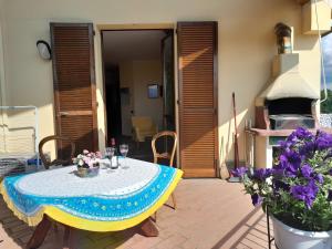 a patio with a table and a pizza oven at Tramonto al Lago in Gavirate