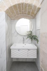 a bathroom with a white sink and a mirror at 2 Love rooms in Corato