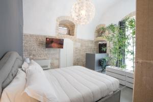 a bedroom with a large bed and a chandelier at 2 Love rooms in Corato