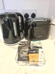 a counter top with a coffee maker and a toaster at Homestay by BIC Oates 4 in Dewsbury