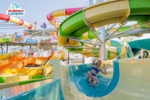 a child on a water slide at a water park at ApartPark Centrum Zator Bronze in Zator