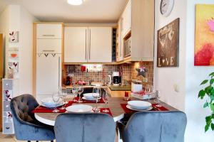 a kitchen with a wooden table with chairs and a dining room at Daheim in Koserow in Koserow