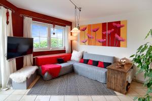 a living room with a couch and a tv at Daheim in Koserow in Ostseebad Koserow