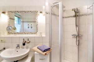 a white bathroom with a sink and a shower at Daheim in Koserow in Ostseebad Koserow +9 photos