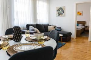 a living room with a couch and a table at Flexible SelfCheckIns 52 - Zagreb - Parking - Loggia in Zagreb