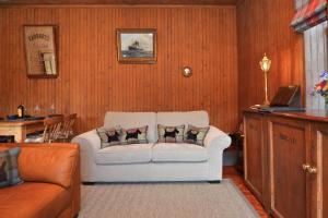 a living room with a white couch with pillows on it at Cairnbaan House in Cairnbaan